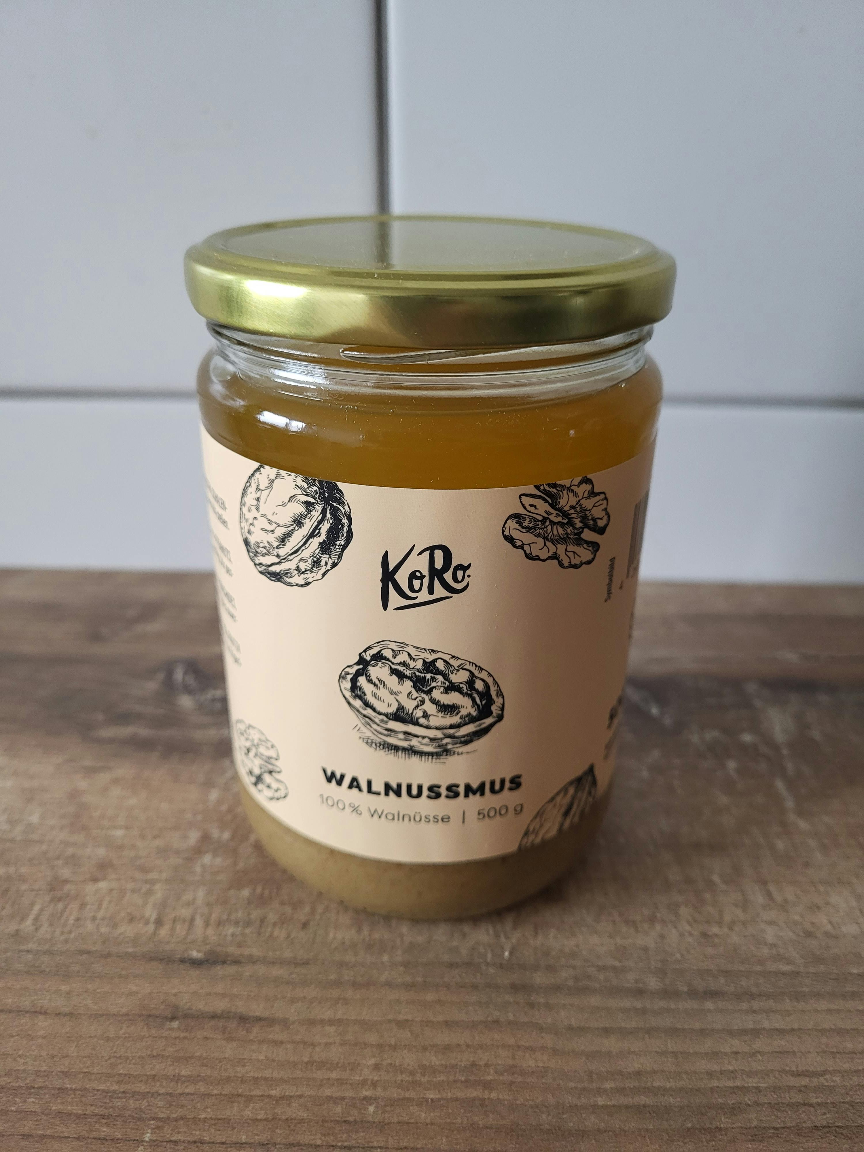 a jar of walnutmus is sitting on a wooden table
