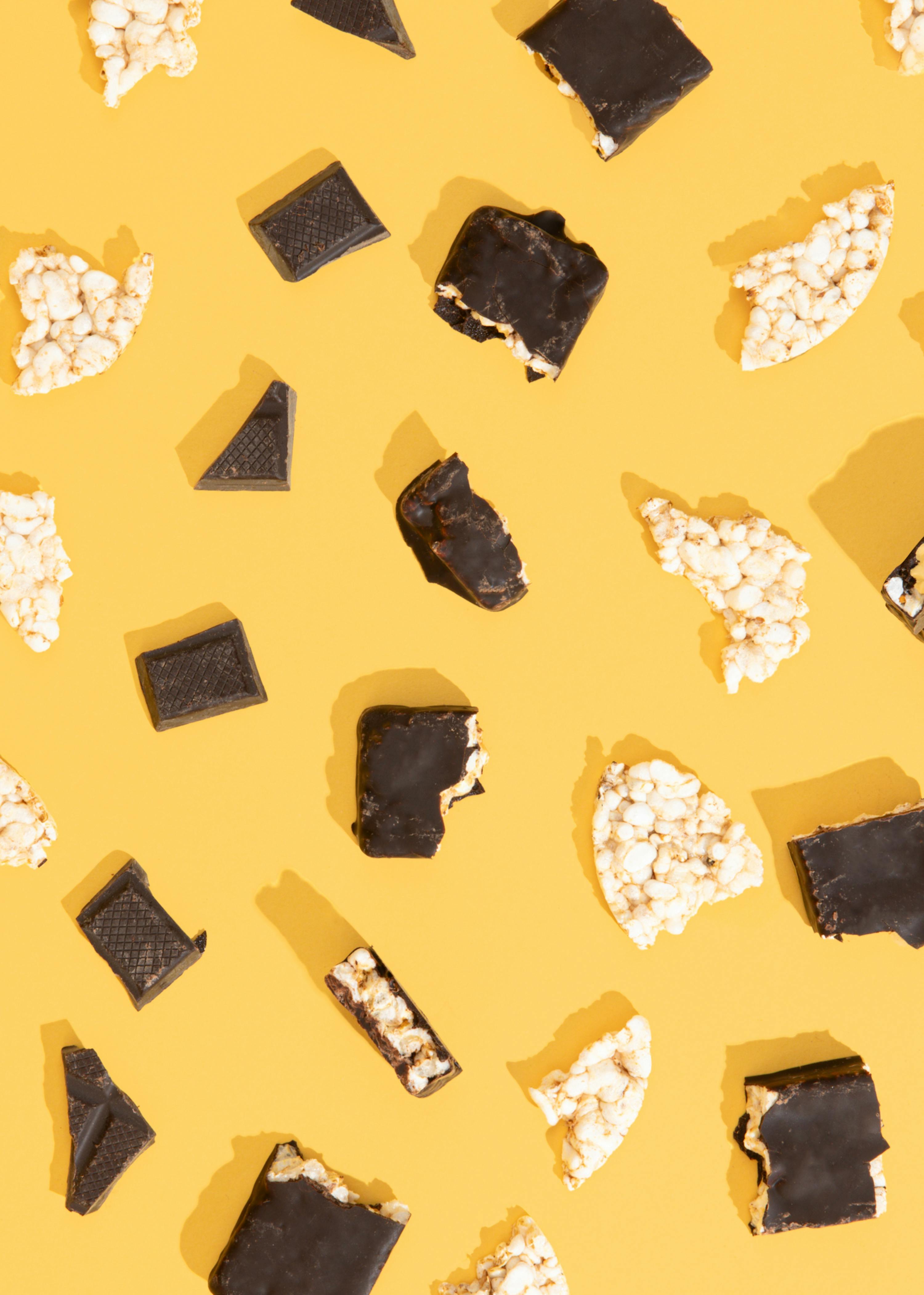 pieces of chocolate and rice crisps on a yellow background