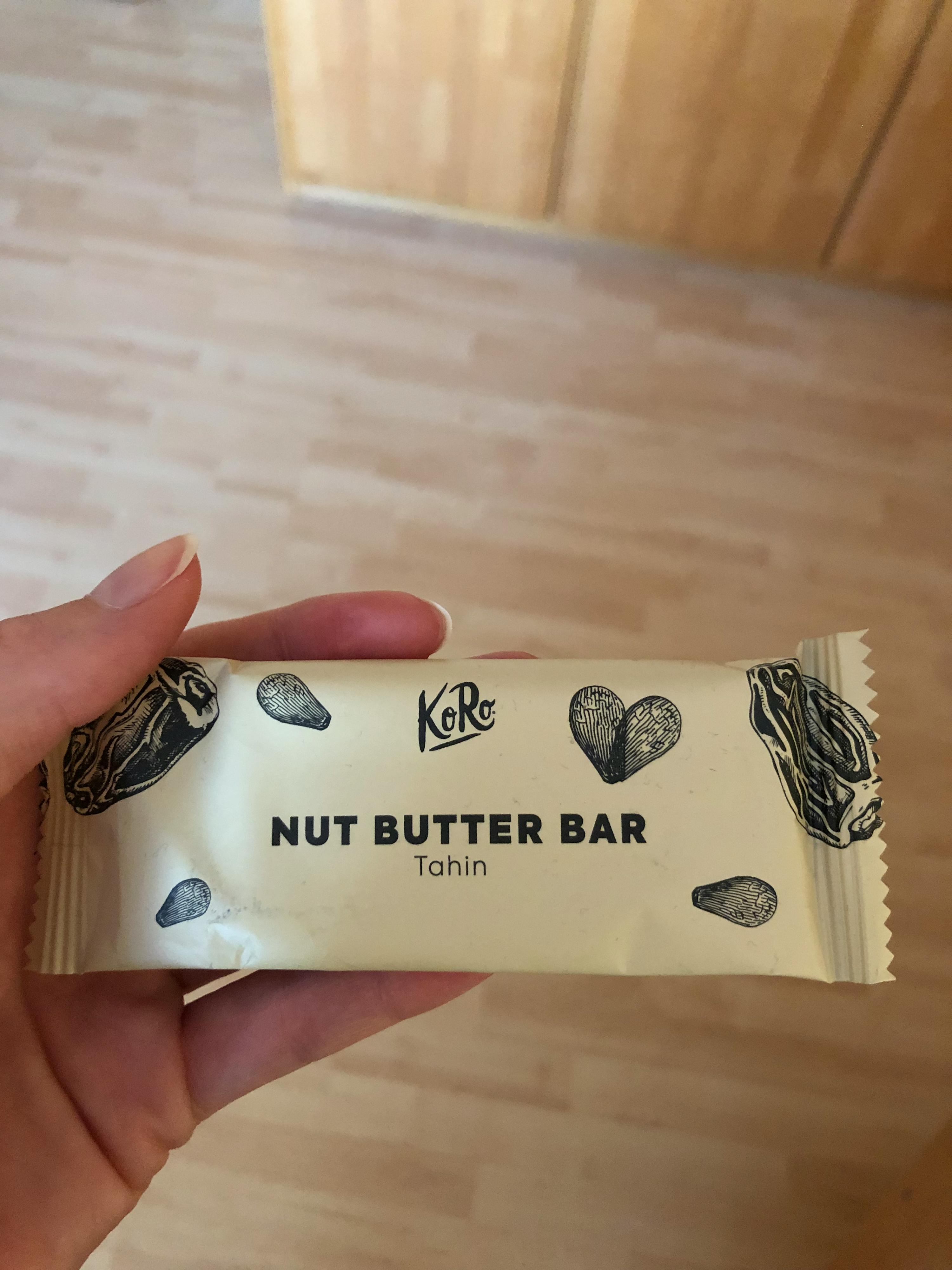a person holding a nut butter bar in their hand