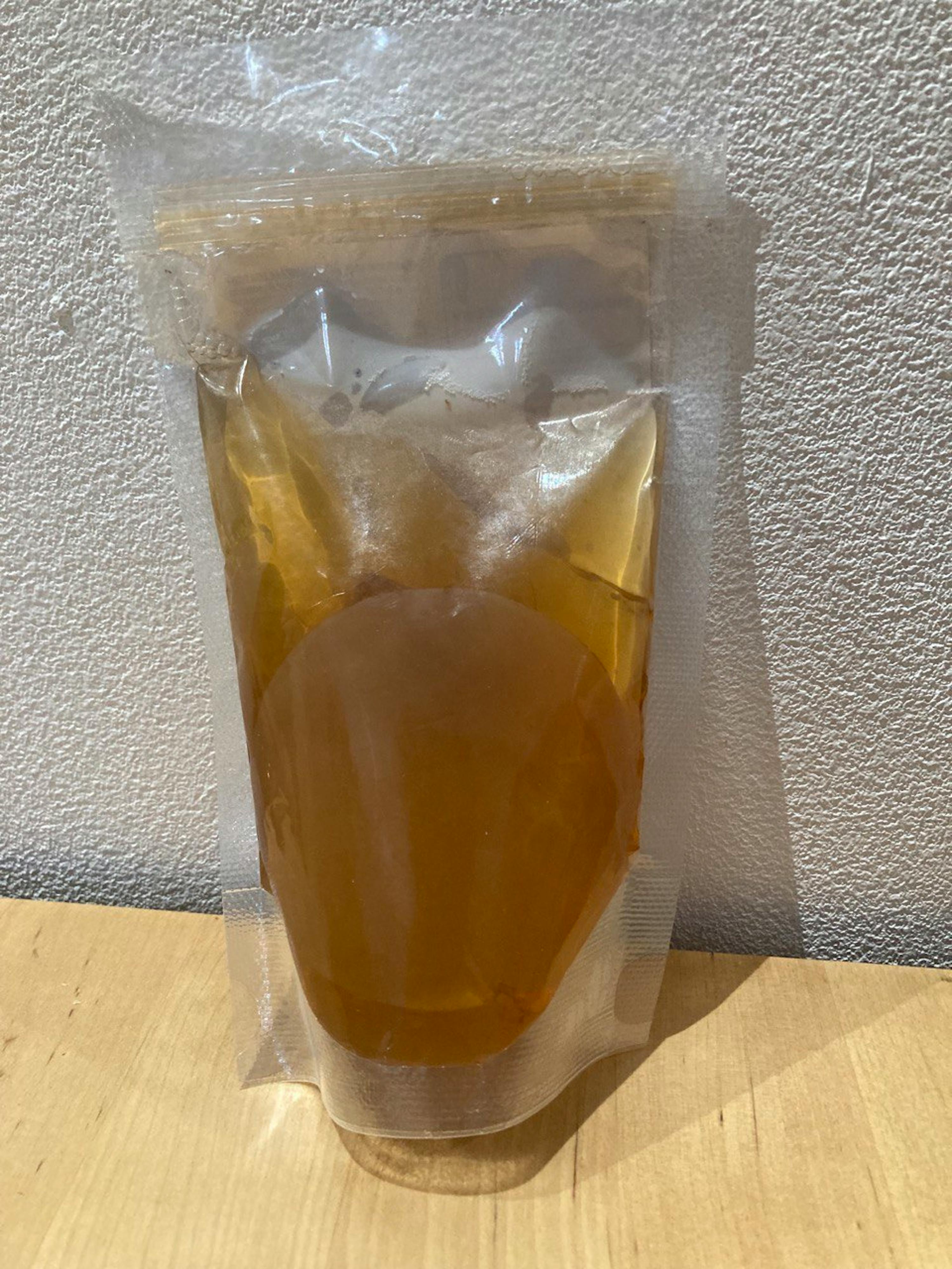 a plastic bag filled with liquid sits on a table