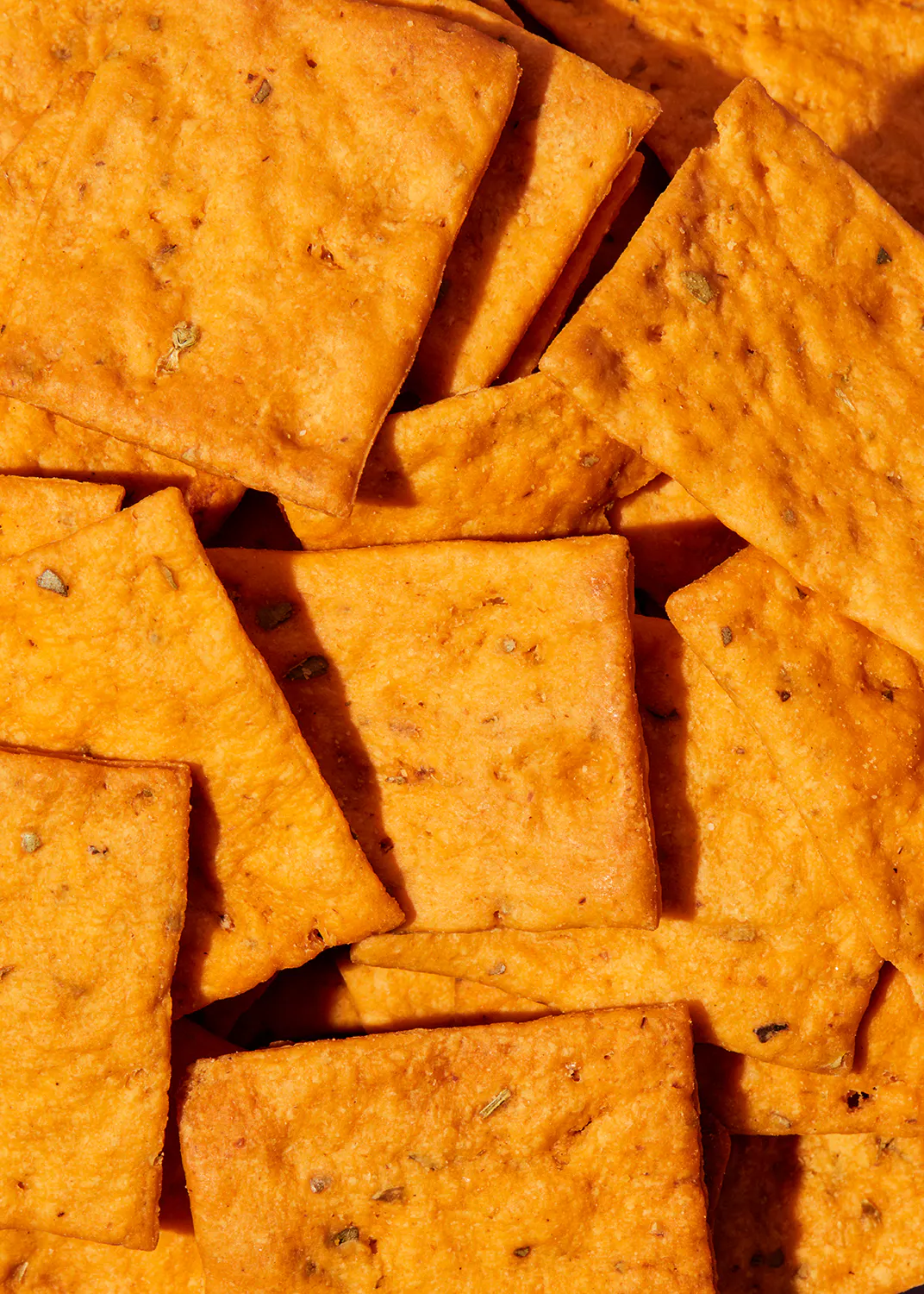 a close up of a pile of orange crackers