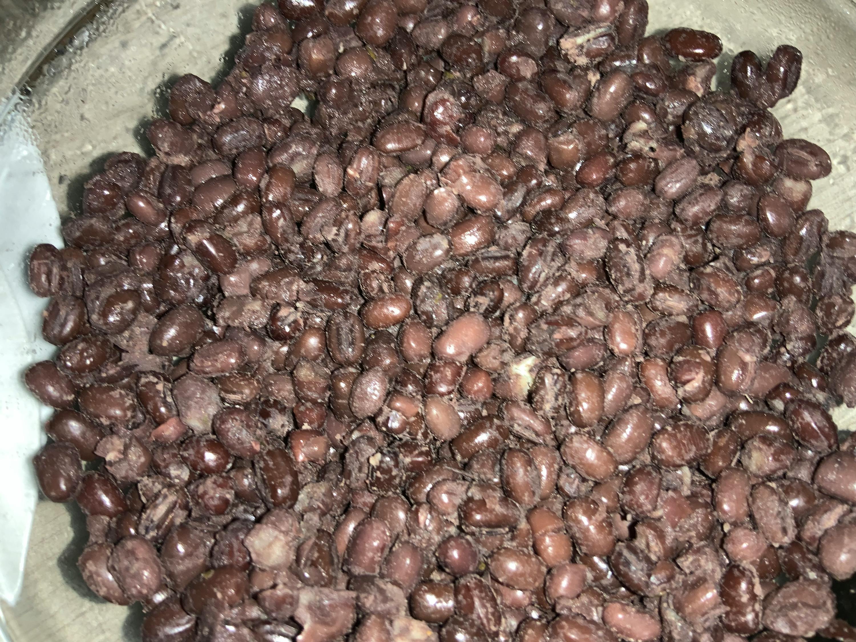 a close up of a pile of black beans