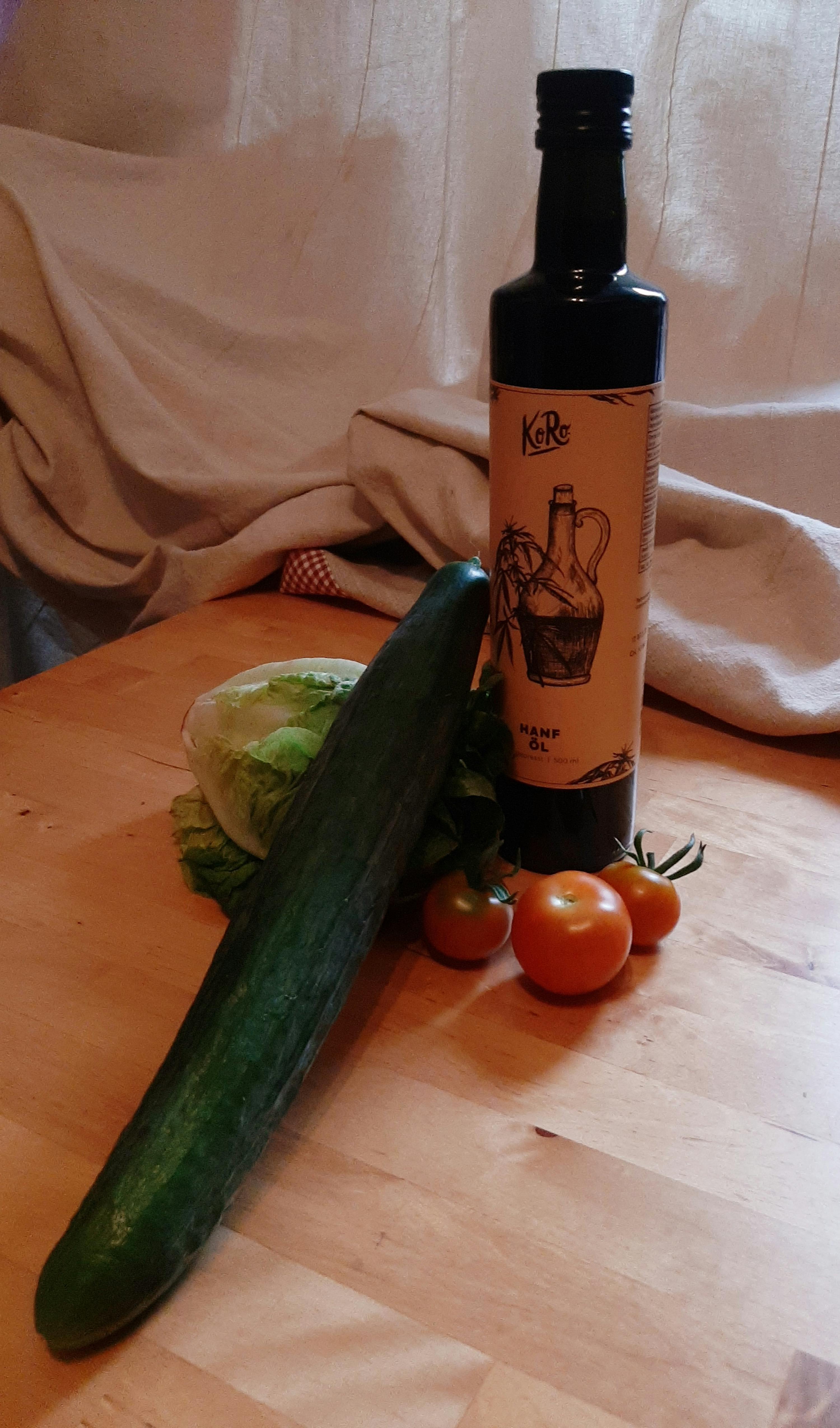 a bottle of hemp oil sits on a wooden table
