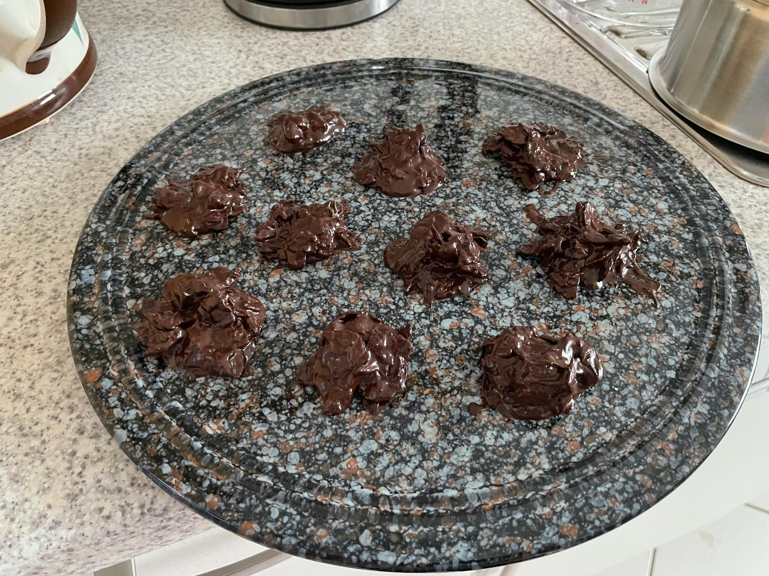 a plate of chocolate covered cookies sits on a counter