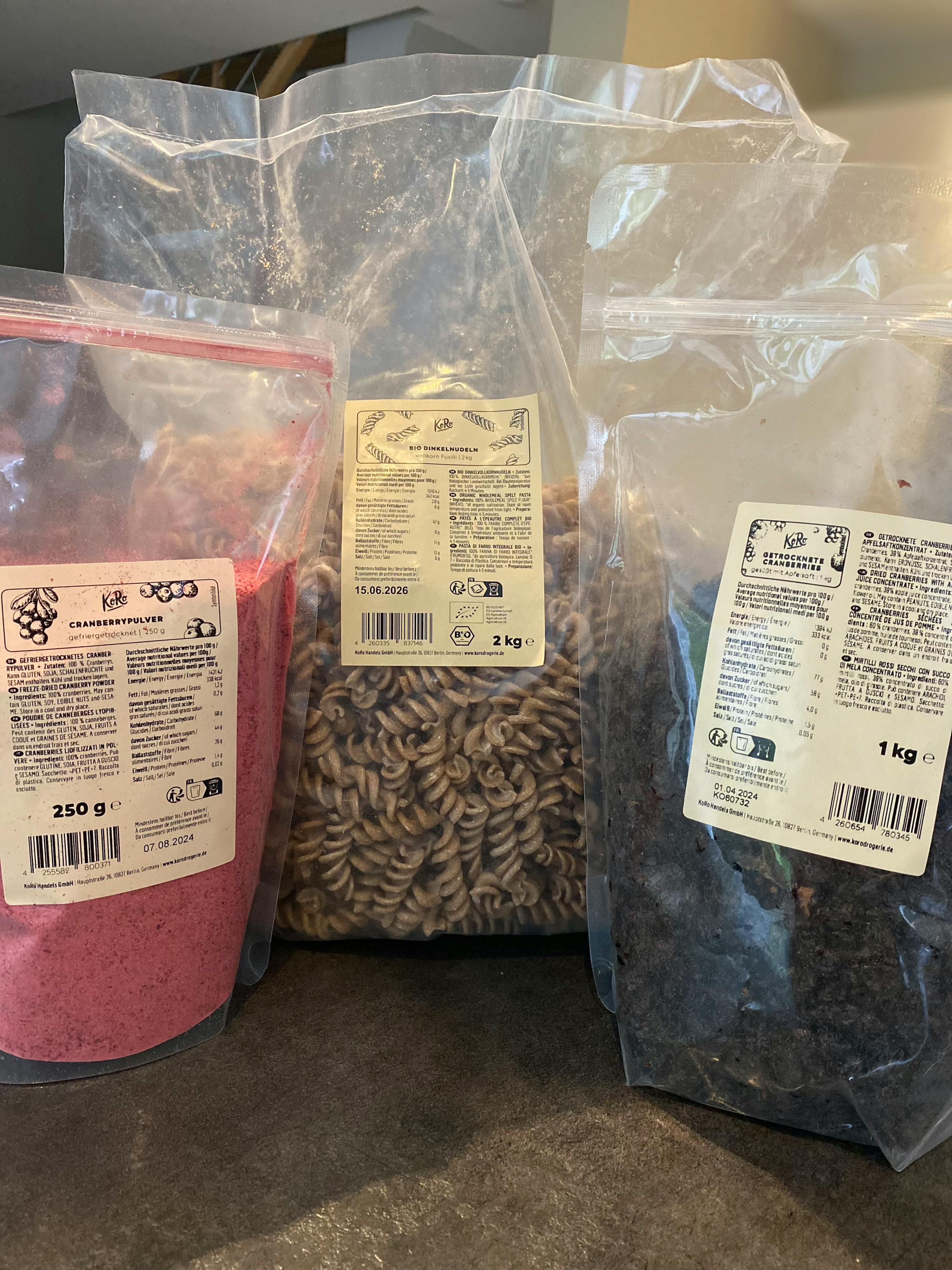 a bag of cranberry powder sits next to a bag of pasta and a bag of dried cranberries