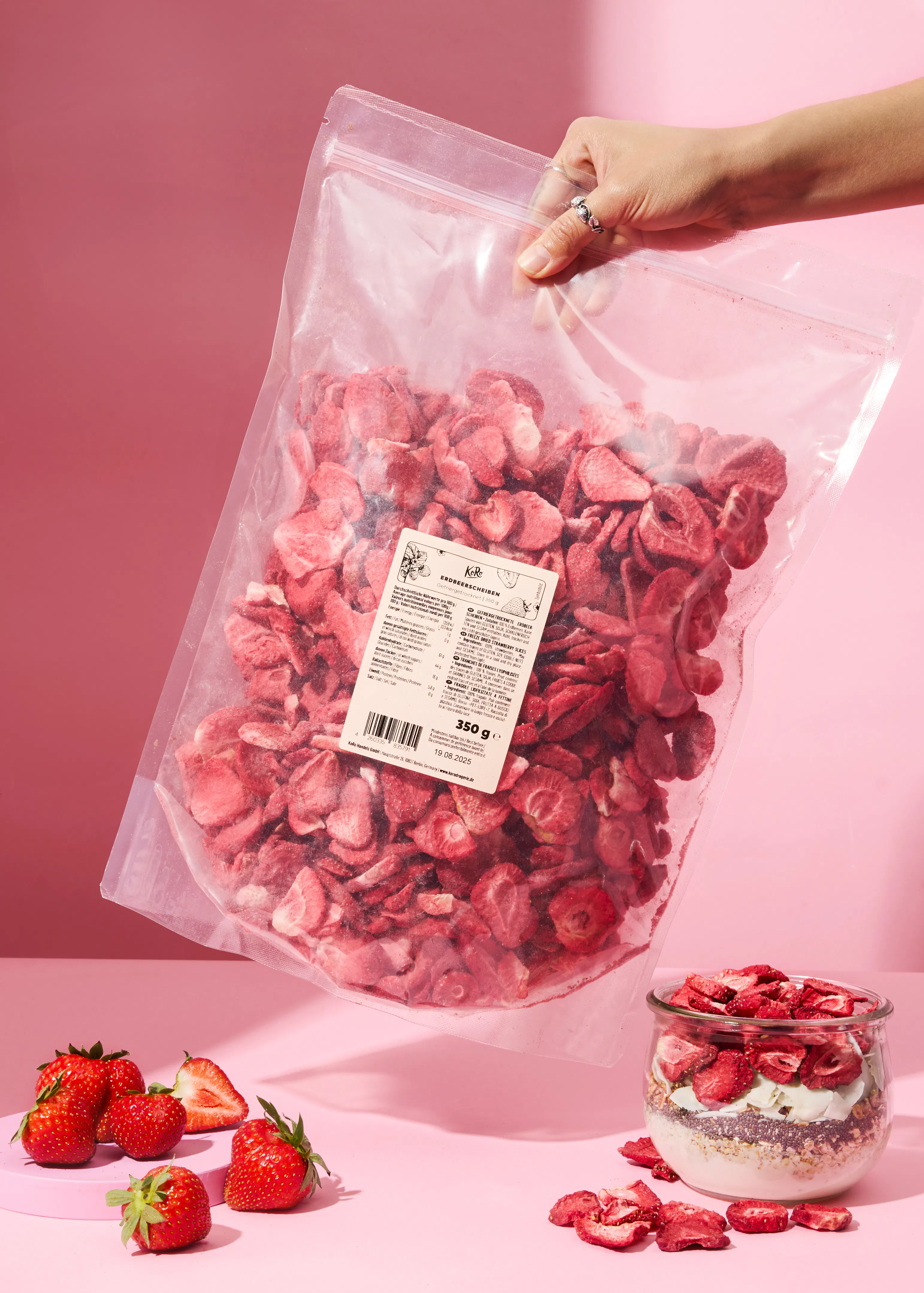 a person is holding a bag of strawberry slices