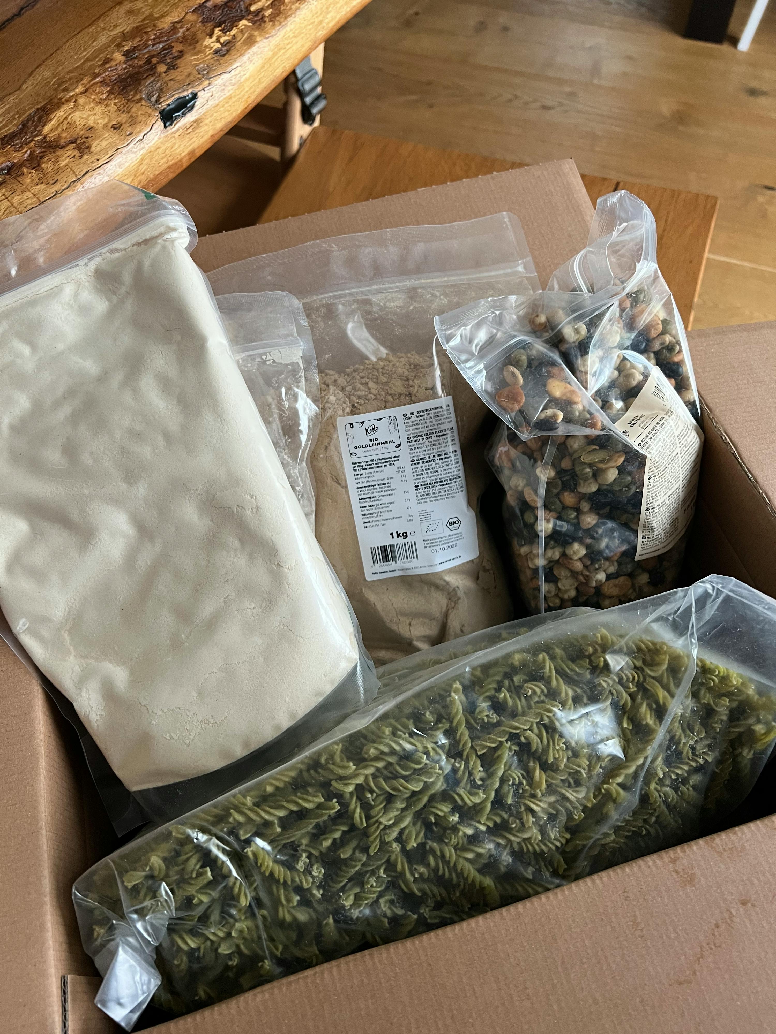 a box filled with a variety of food items including pasta and nuts