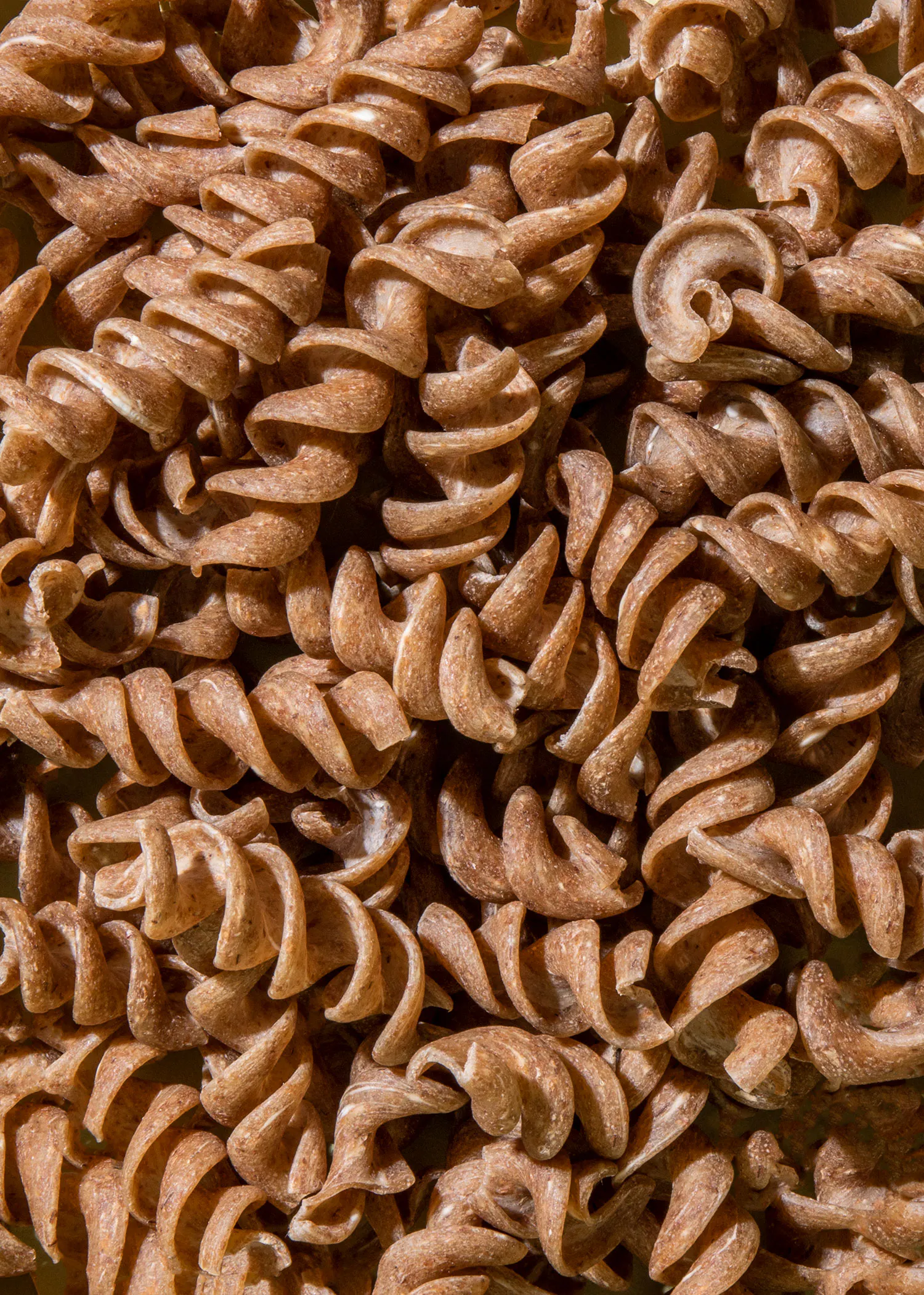 a close up of a pile of brown pasta