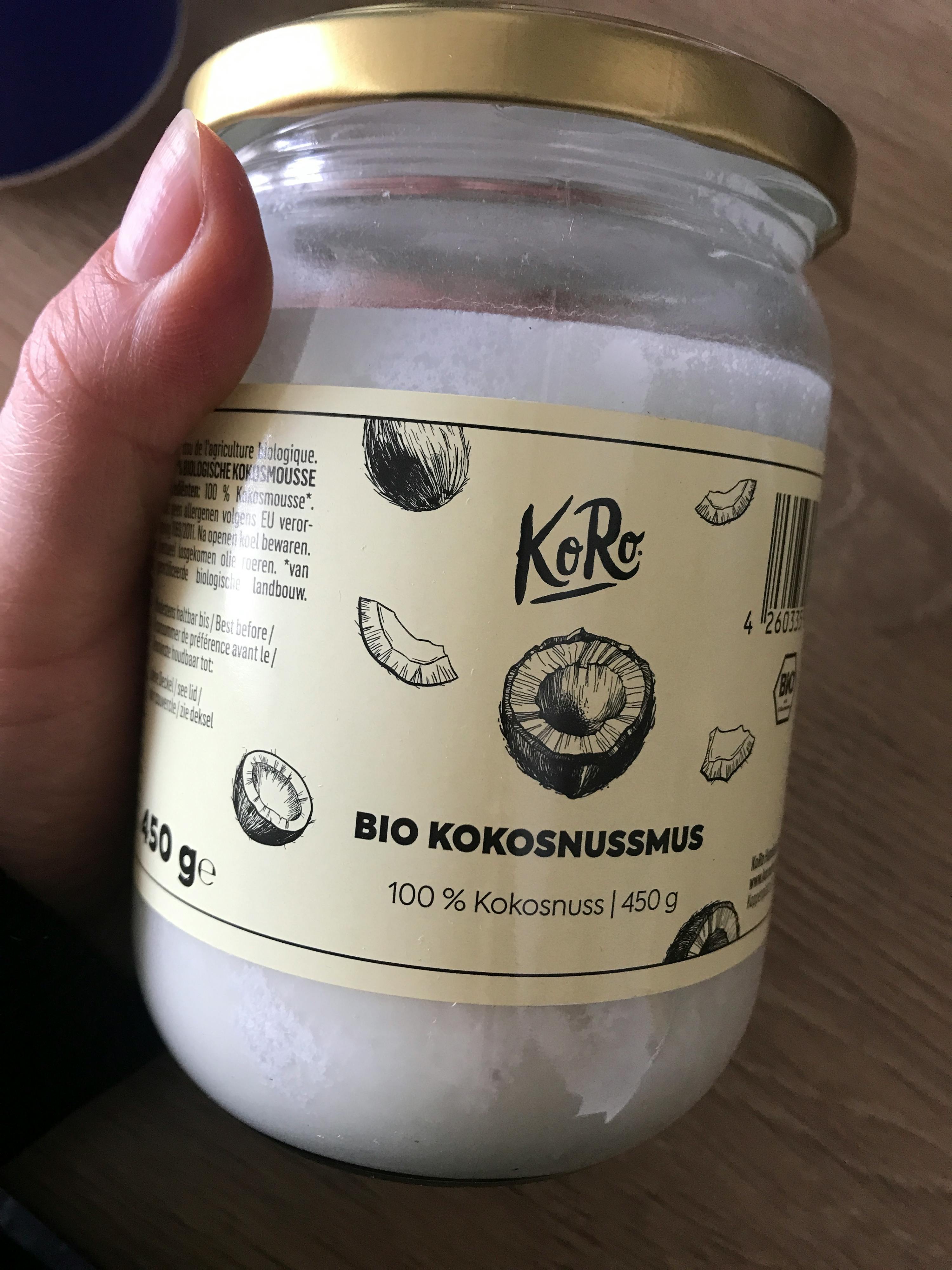 someone is holding a jar of bio kokosnussmus