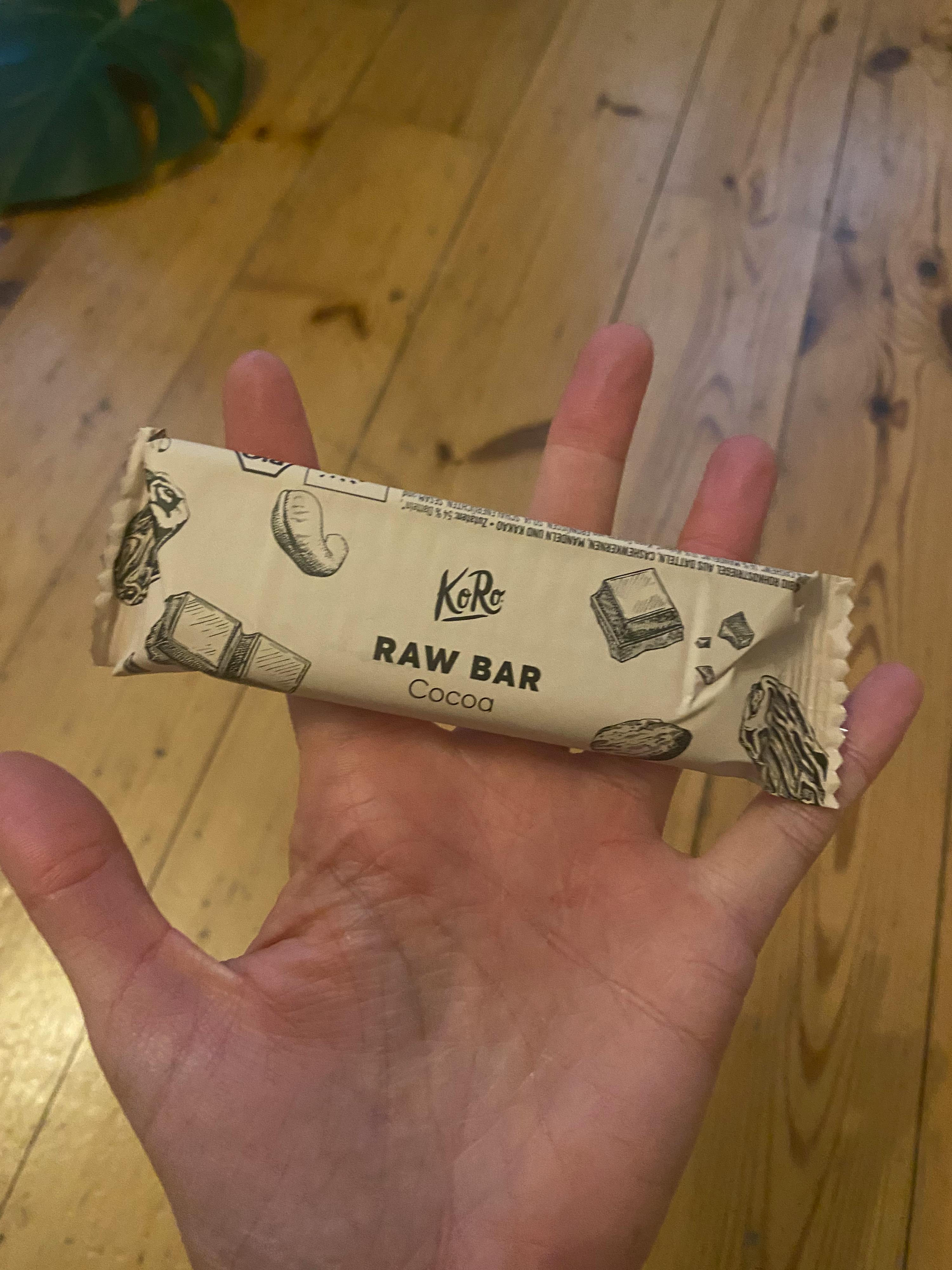 a person is holding a bar that says raw bar cocoa