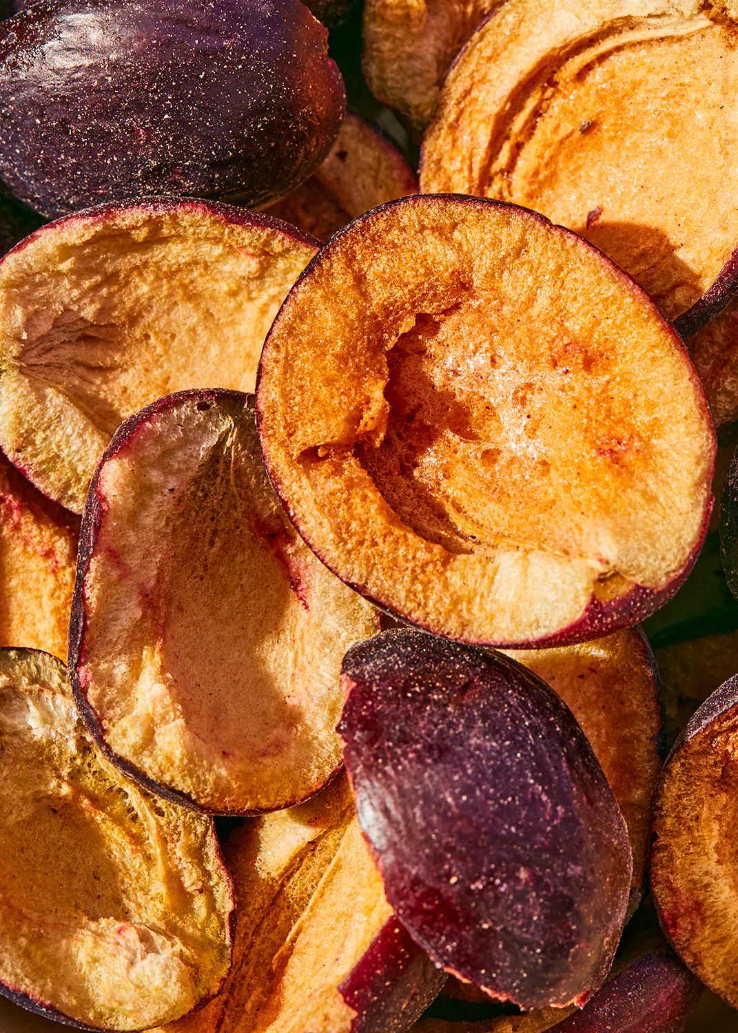 a close up of a pile of sliced plums