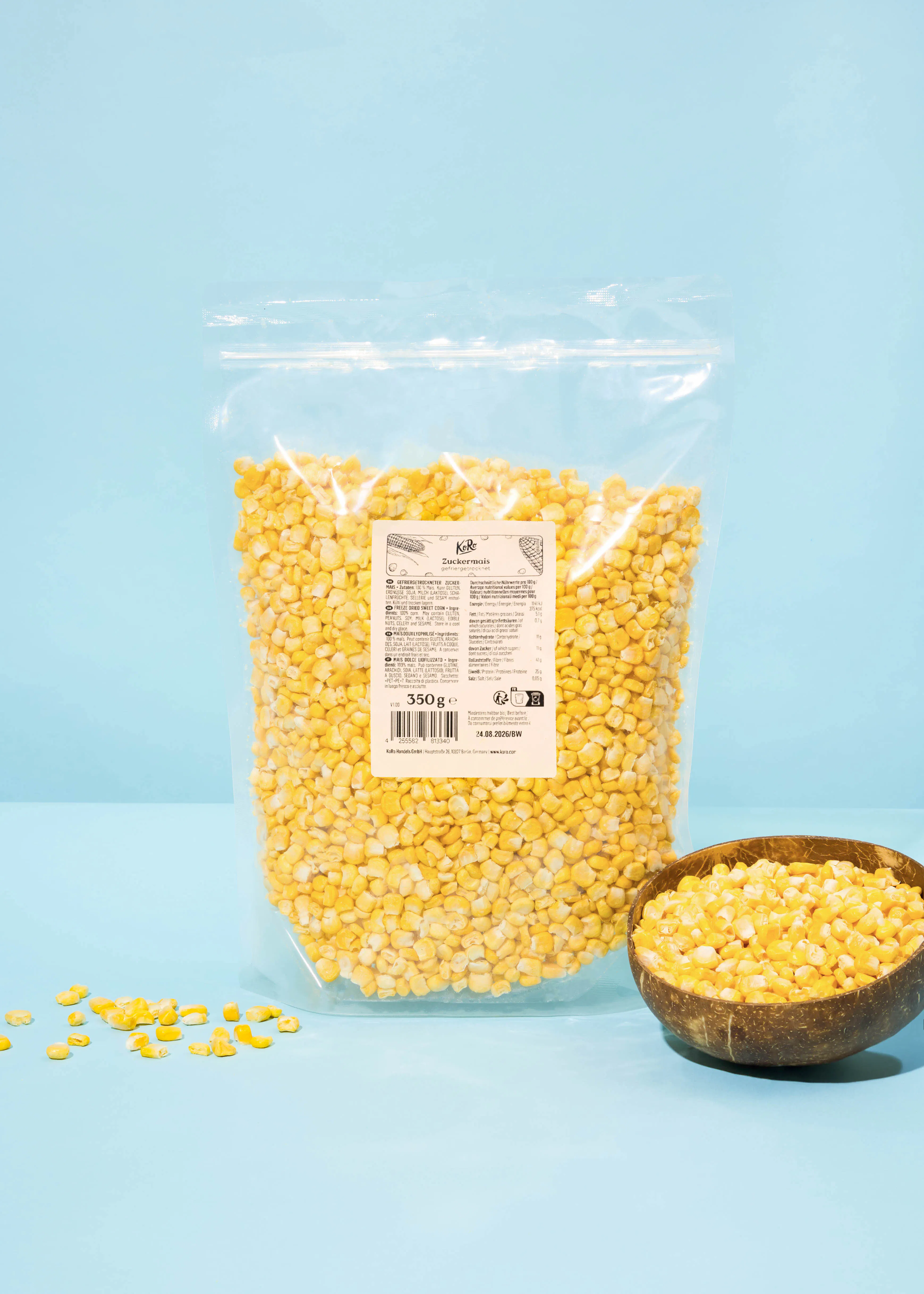 a bag of corn sits on a table next to a bowl of corn