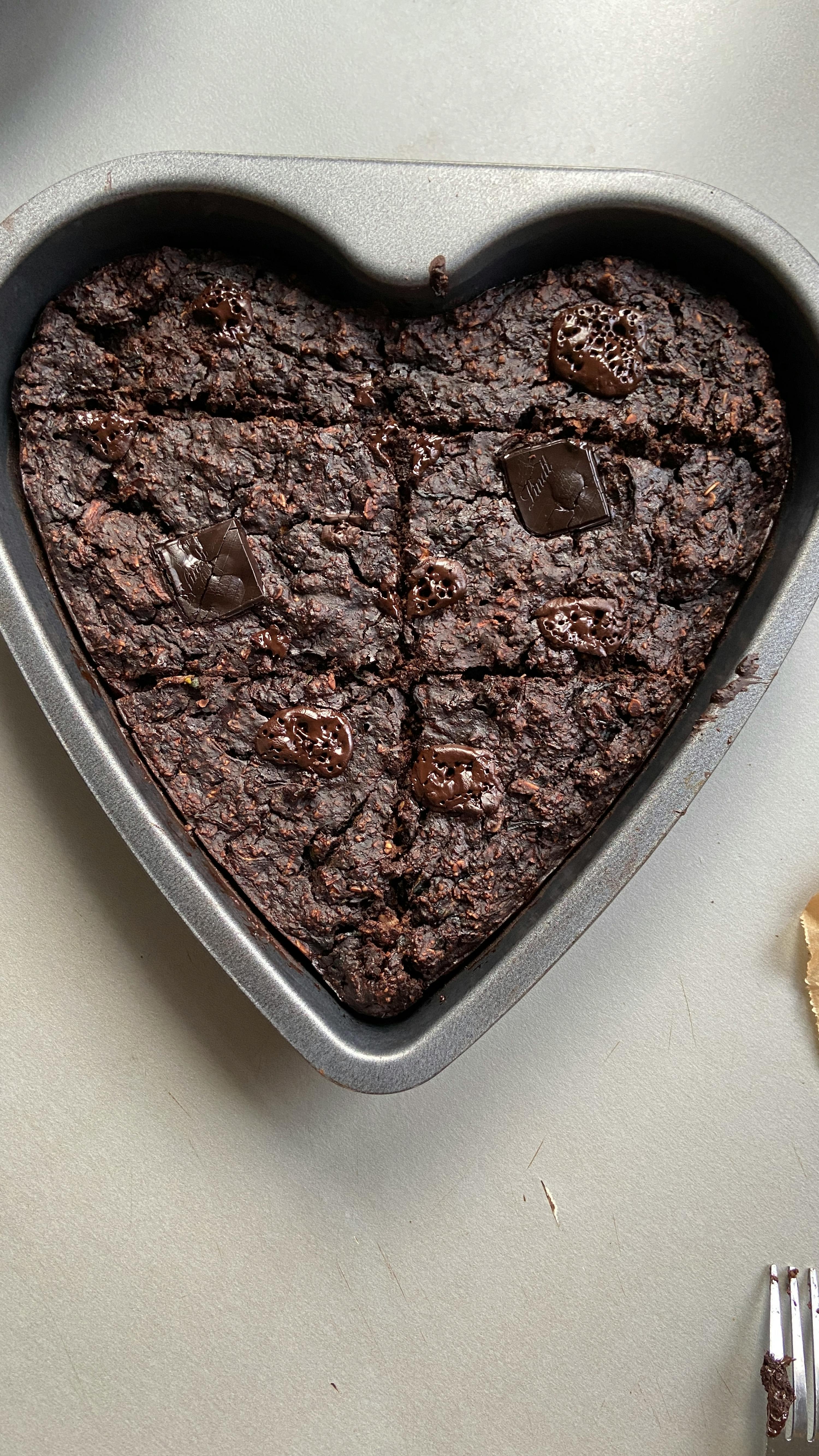 a heart shaped pan filled with a brownie with chocolate chips