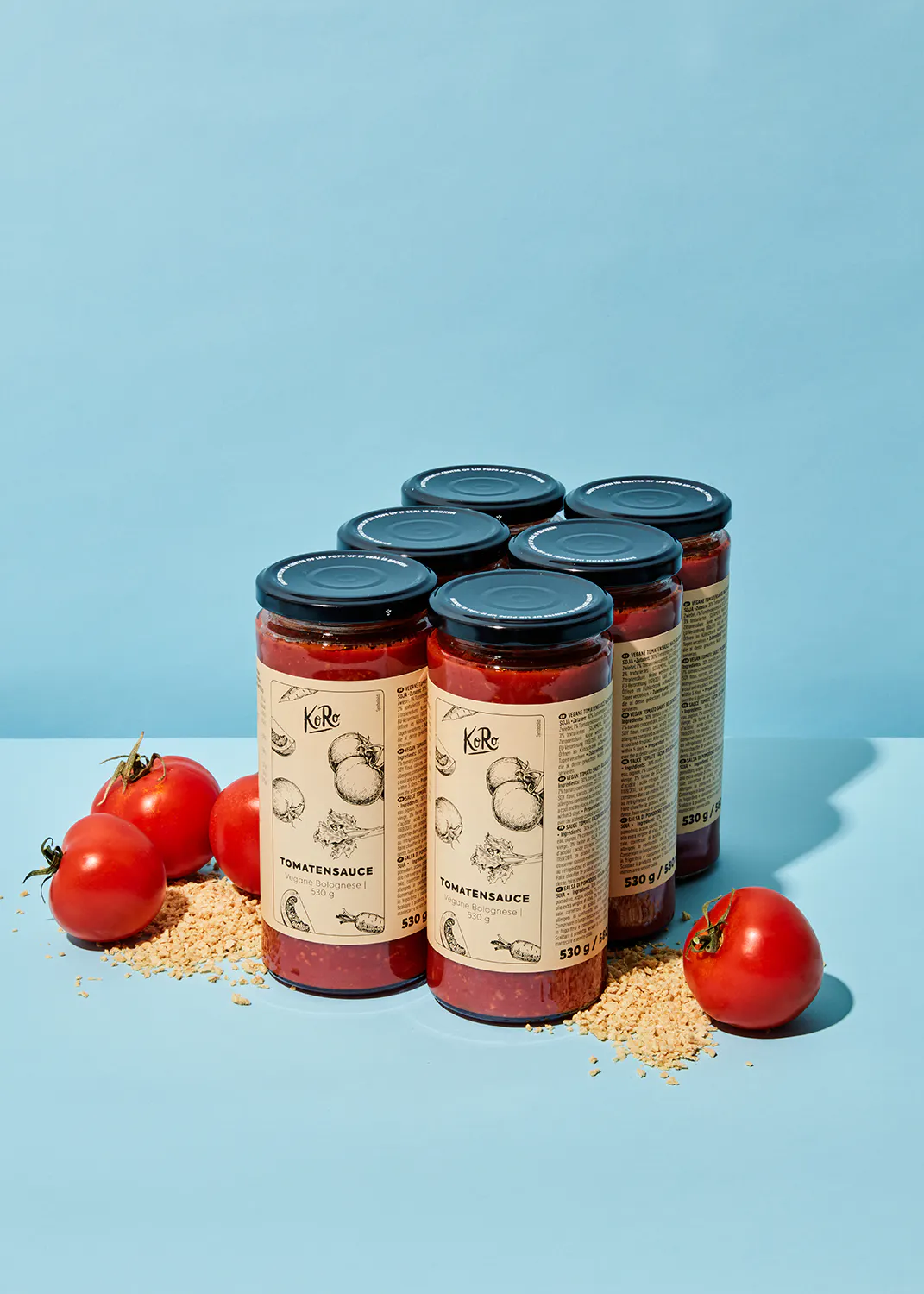 six jars of tomato sauce are sitting on a blue surface