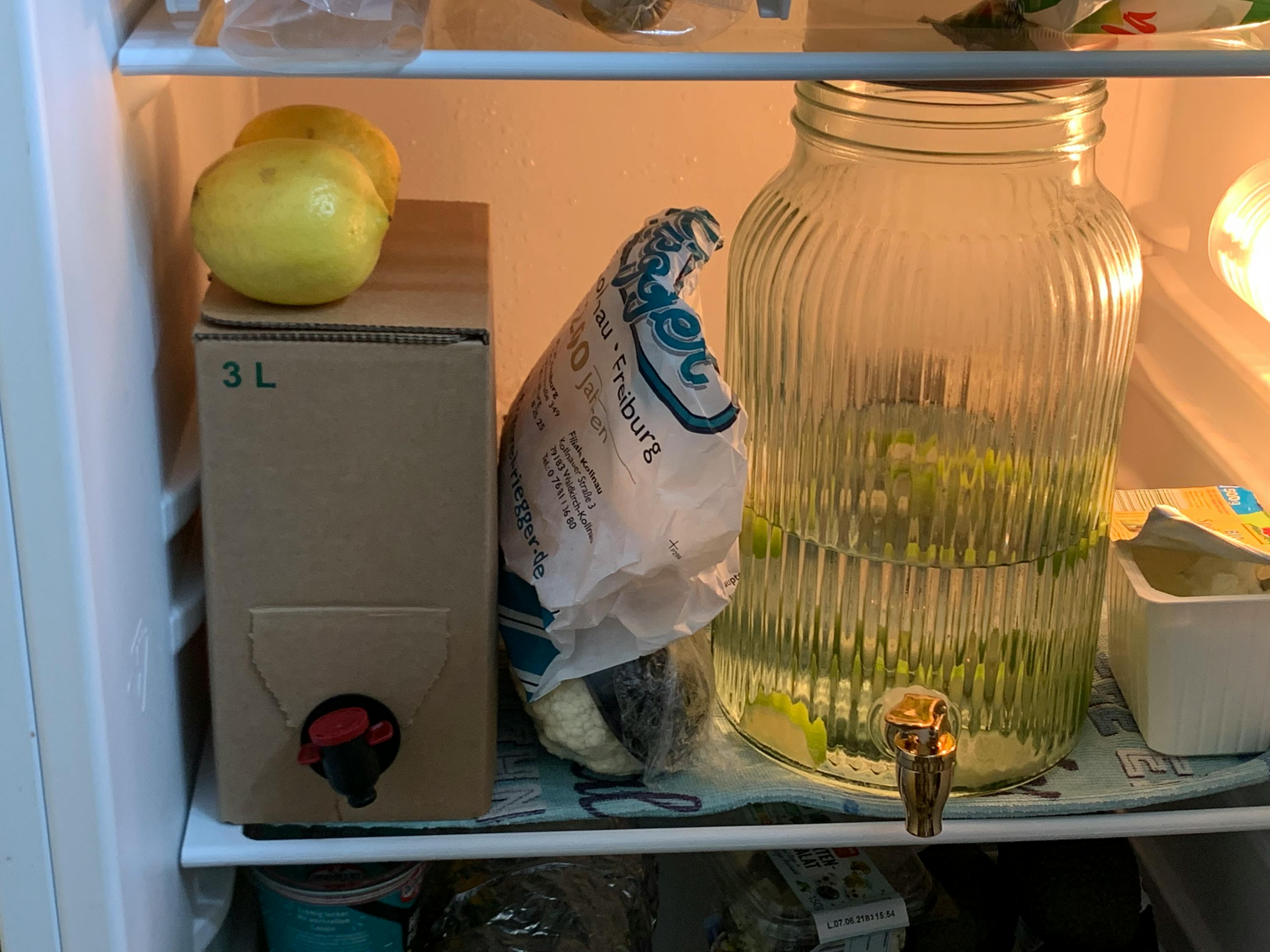 a bag of french fries sits on a shelf in a fridge