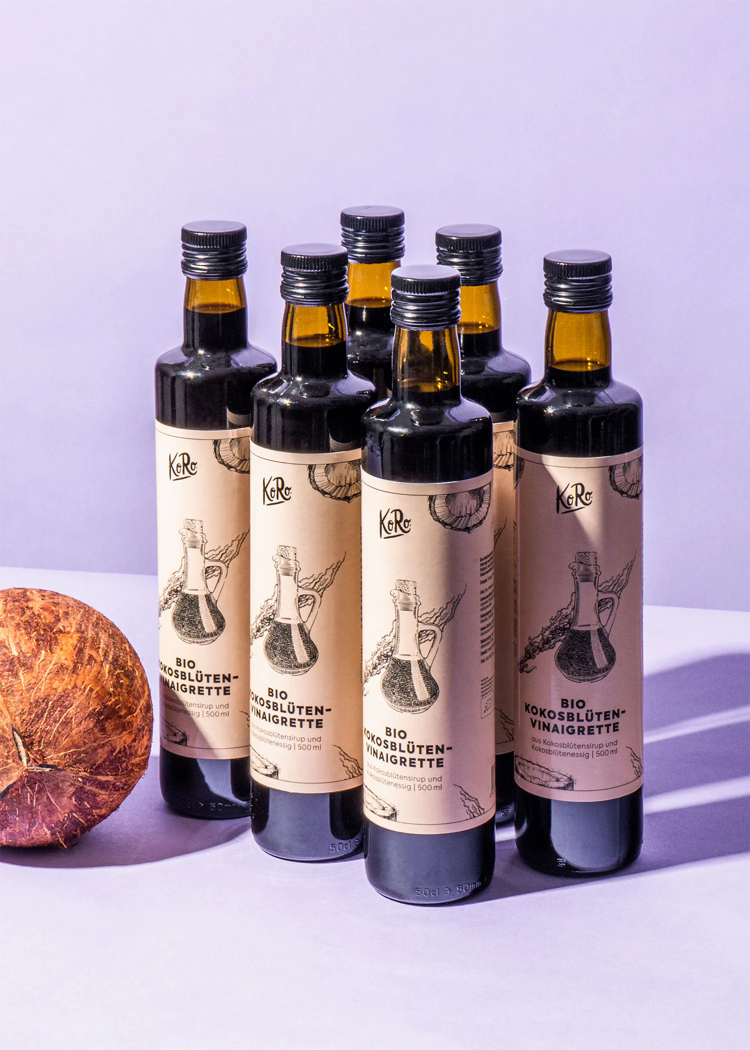 six bottles of bio coconut vinaigrette sit on a table