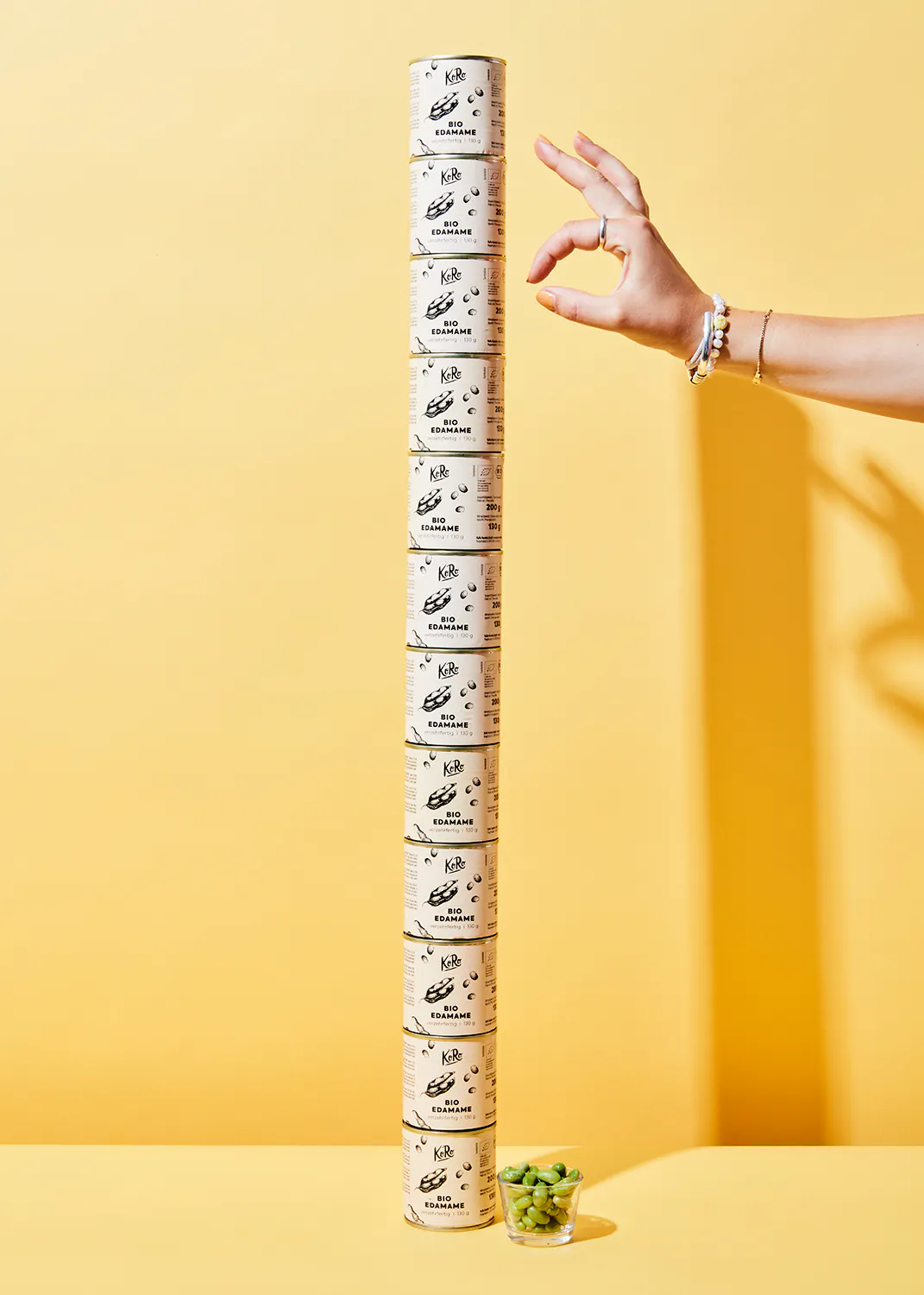 a person is reaching for a can of kib