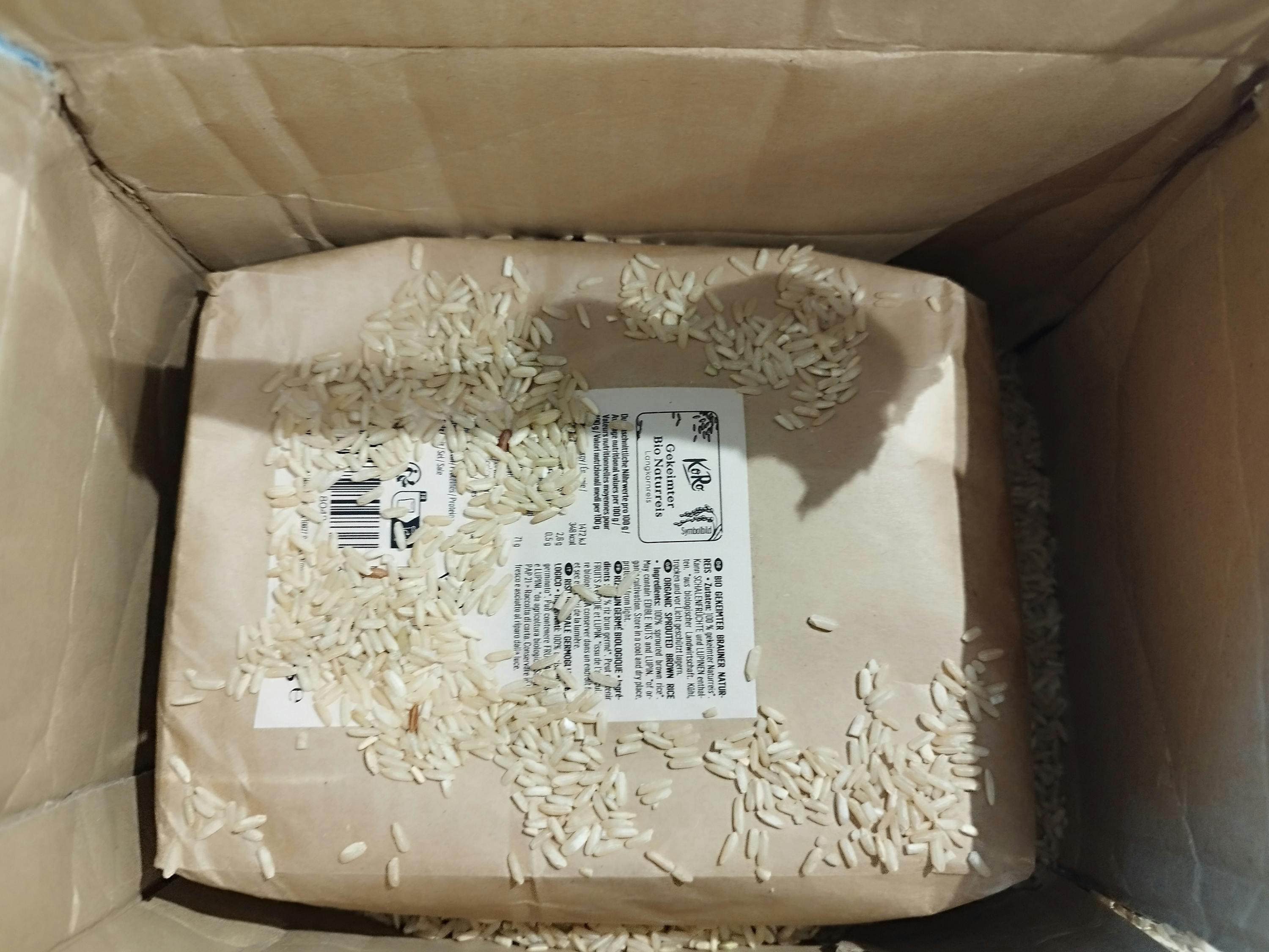 a bag of white rice is in a cardboard box
