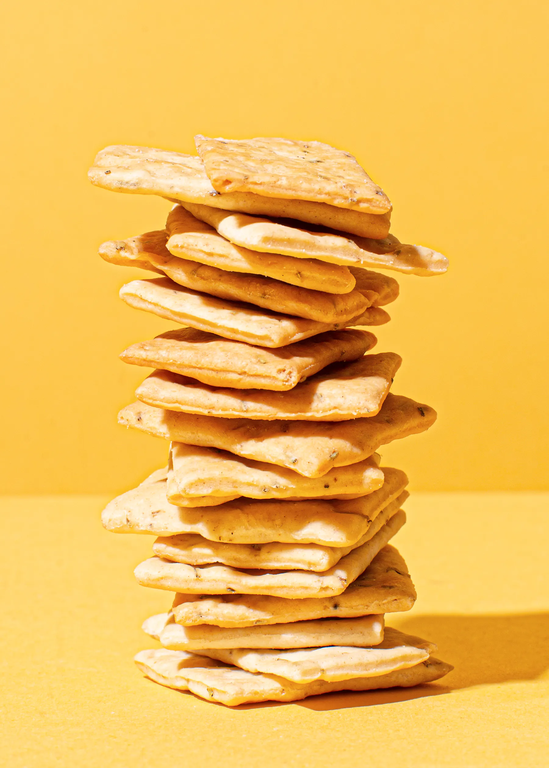 a stack of crackers against a yellow background
