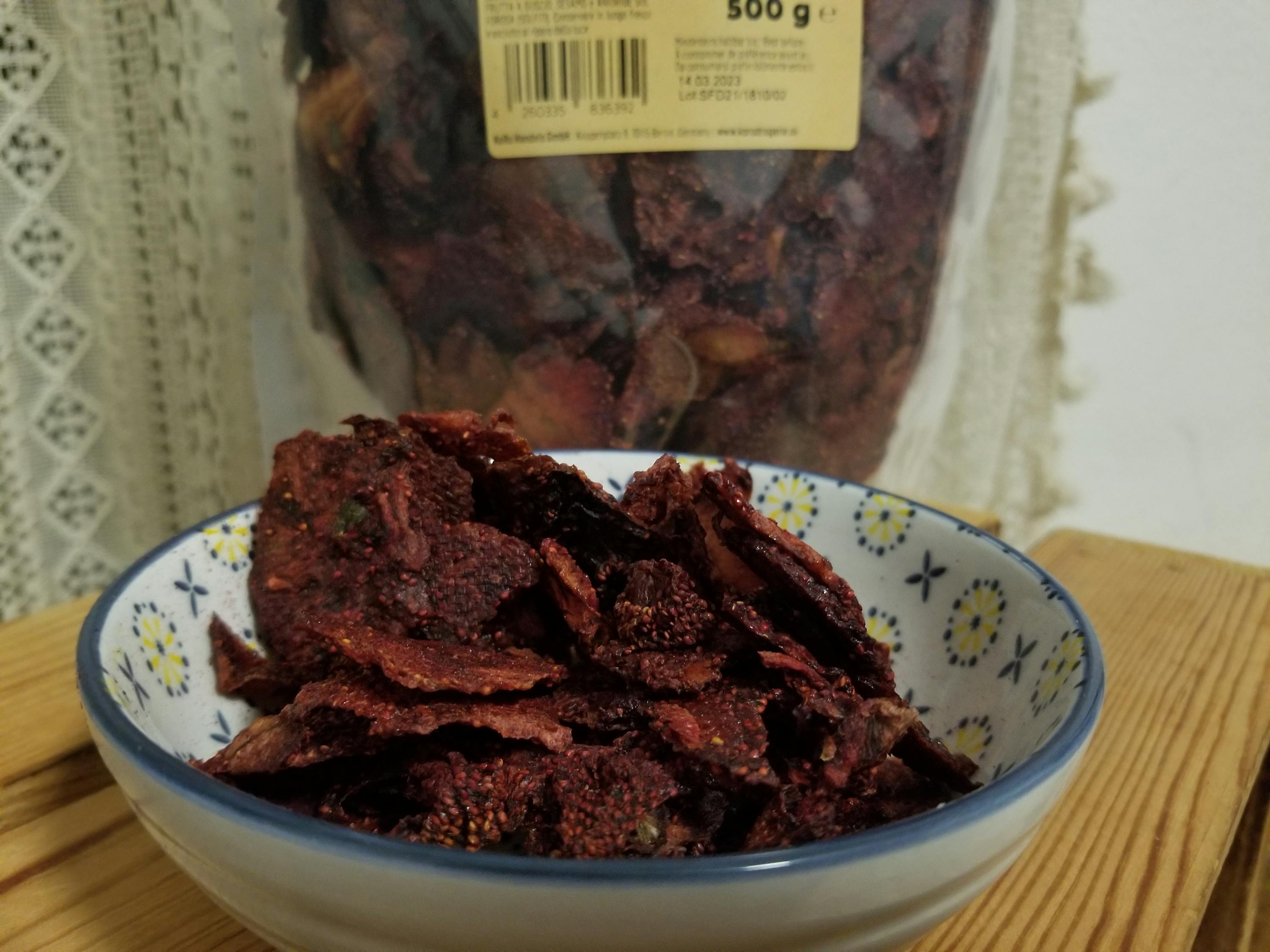 a bowl of food with a bag of food behind it