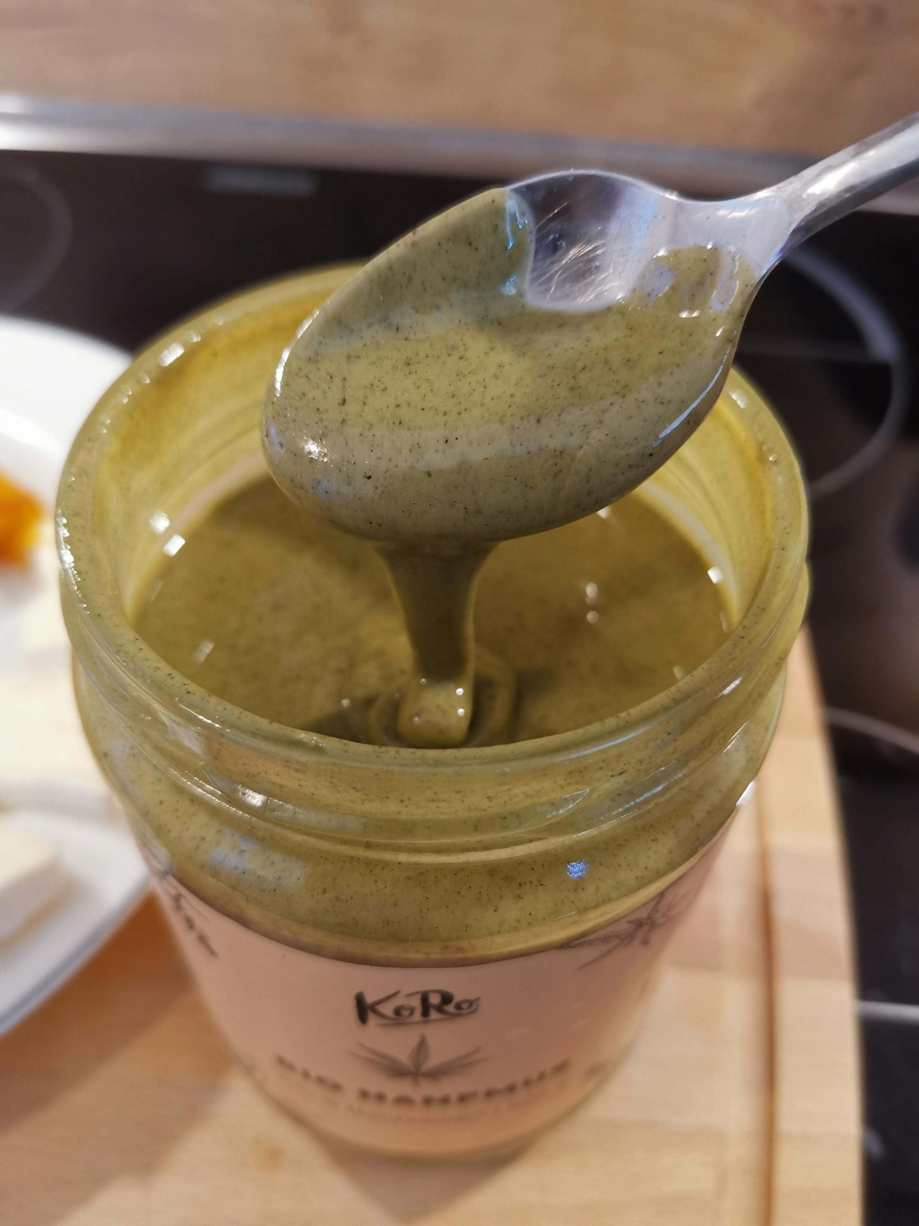 a spoon is sticking out of a jar that says " kore " on it