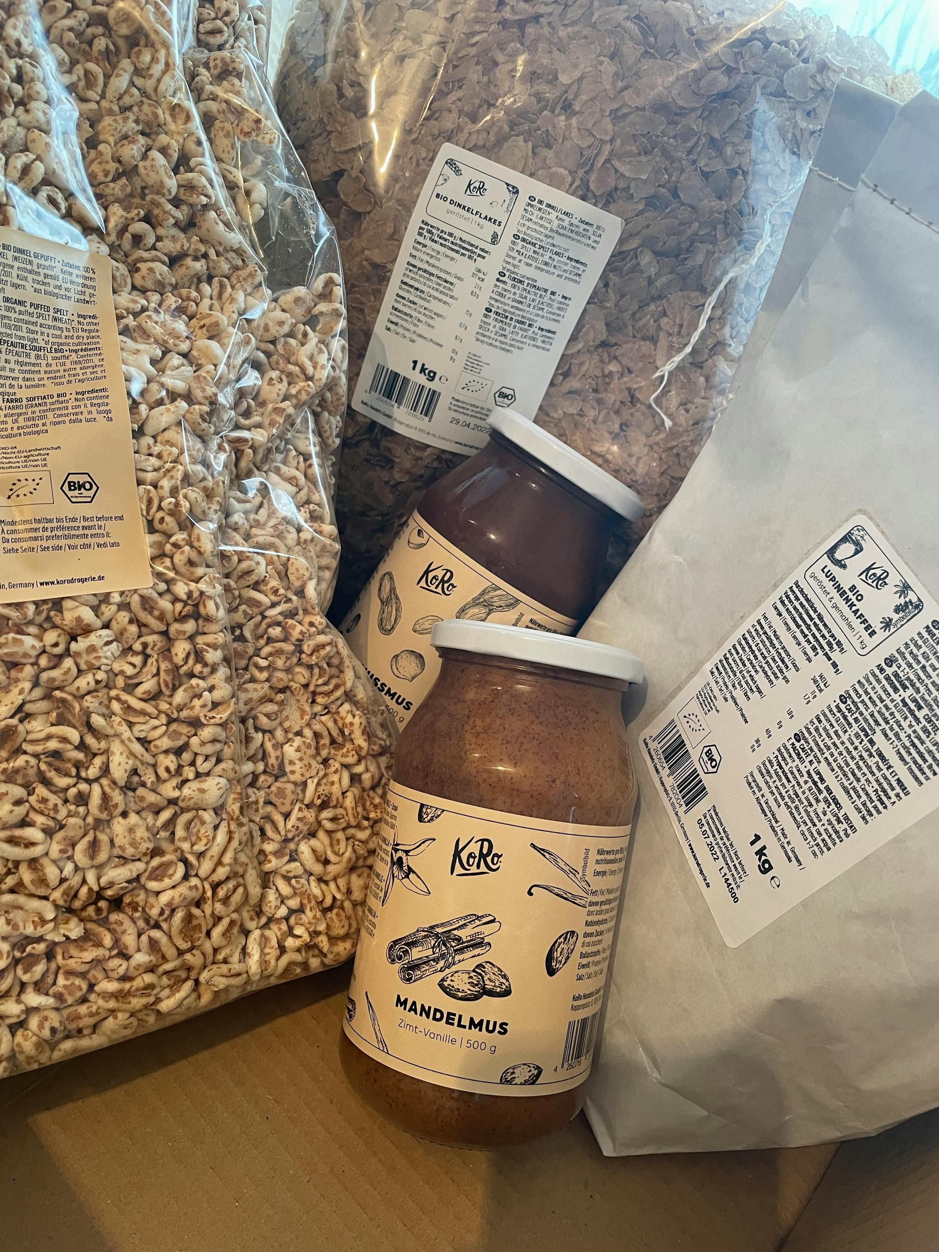 a jar of mandelmus sits on top of a pile of cereal